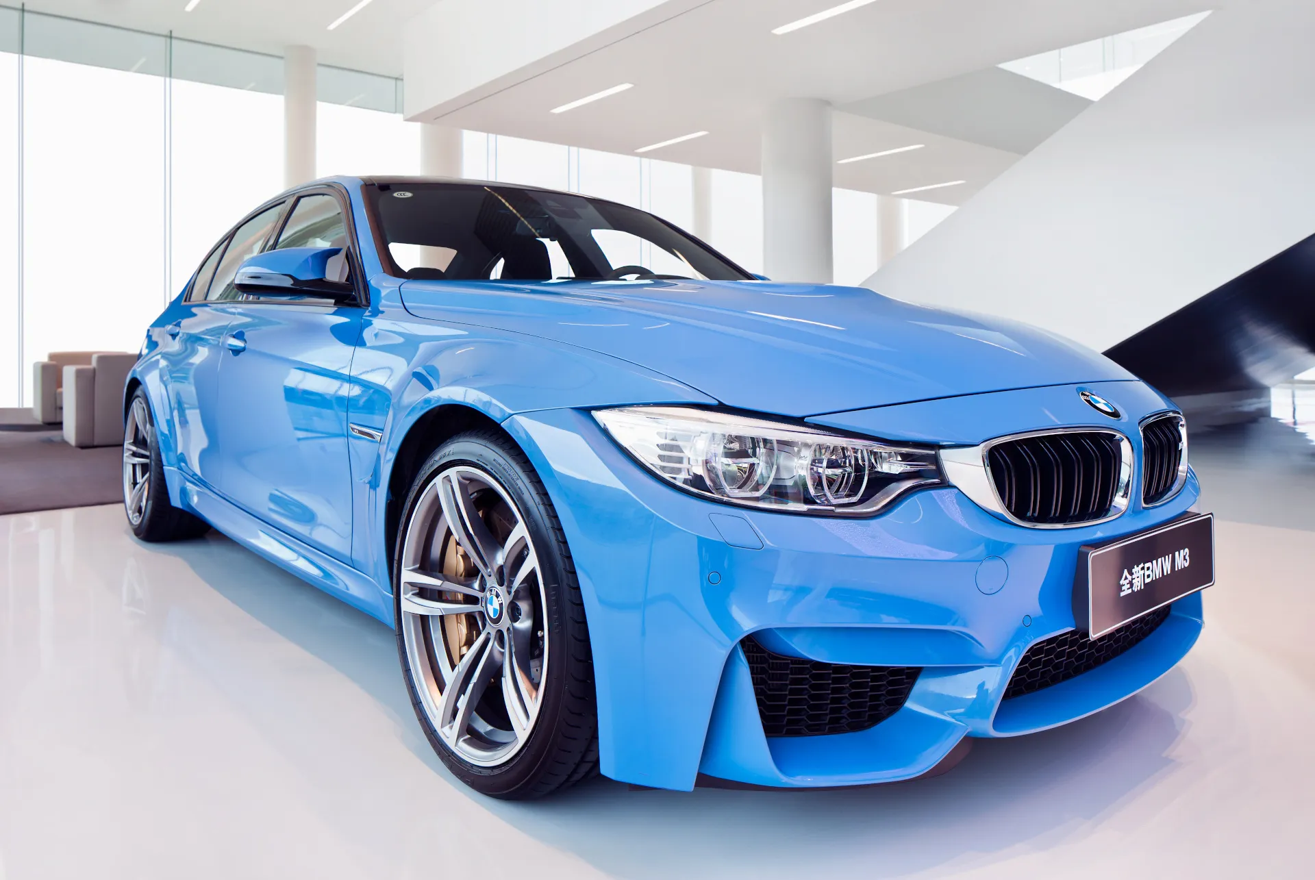 A light blue BMW M3